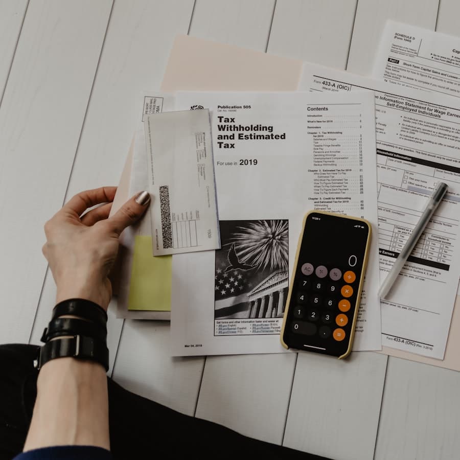 Financial paperwork and a calculator laid out on a desk